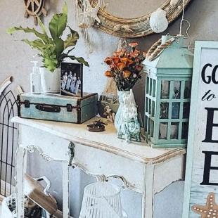 white washed colored foyer table with beach themed decor elements and mirror