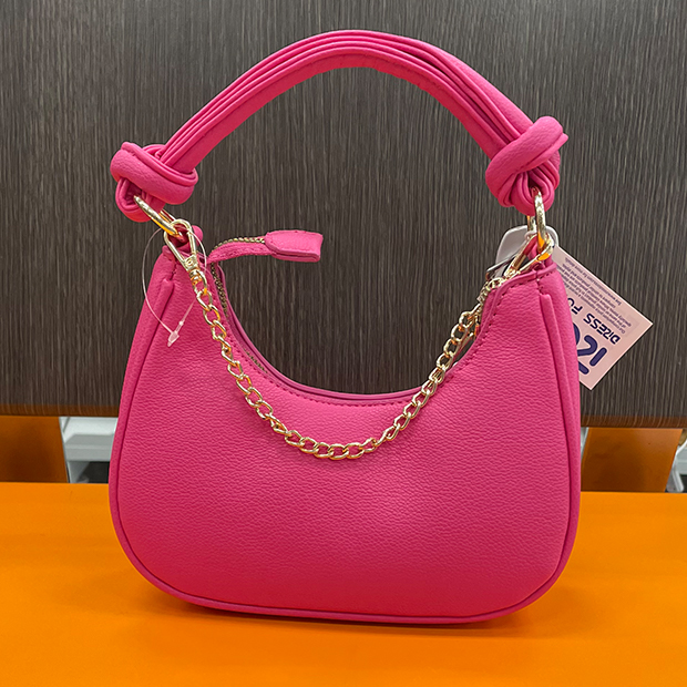 Bright pink hand bag with chain detailing at a Ross store.