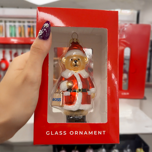 Glass Christmas ornament featuring a teddy bear dressed in a red Santa suit inside a red box.