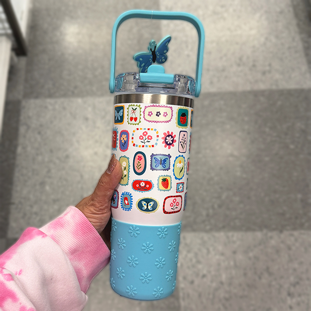 Light blue insulated water bottle with colorful patterns and a carry handle, found in store at Ross.